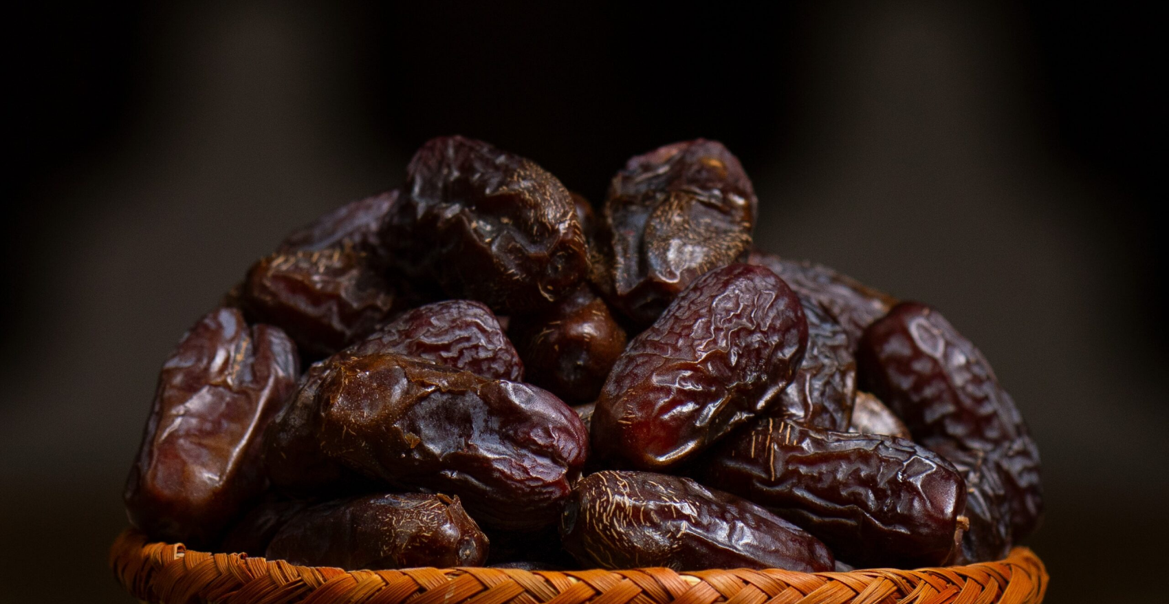 close-up-macro-shot-of-ajwa-dates-in-abrown-color-wooden-bowl-high-resolution