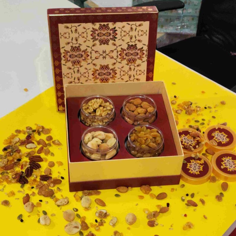 Sufyan Heritage Maroon and Gold 4-Jar Dry Fruit Gift Box featuring clear jars filled with walnuts, almonds, cashews, and raisins with Mughal ornamental lid artwork