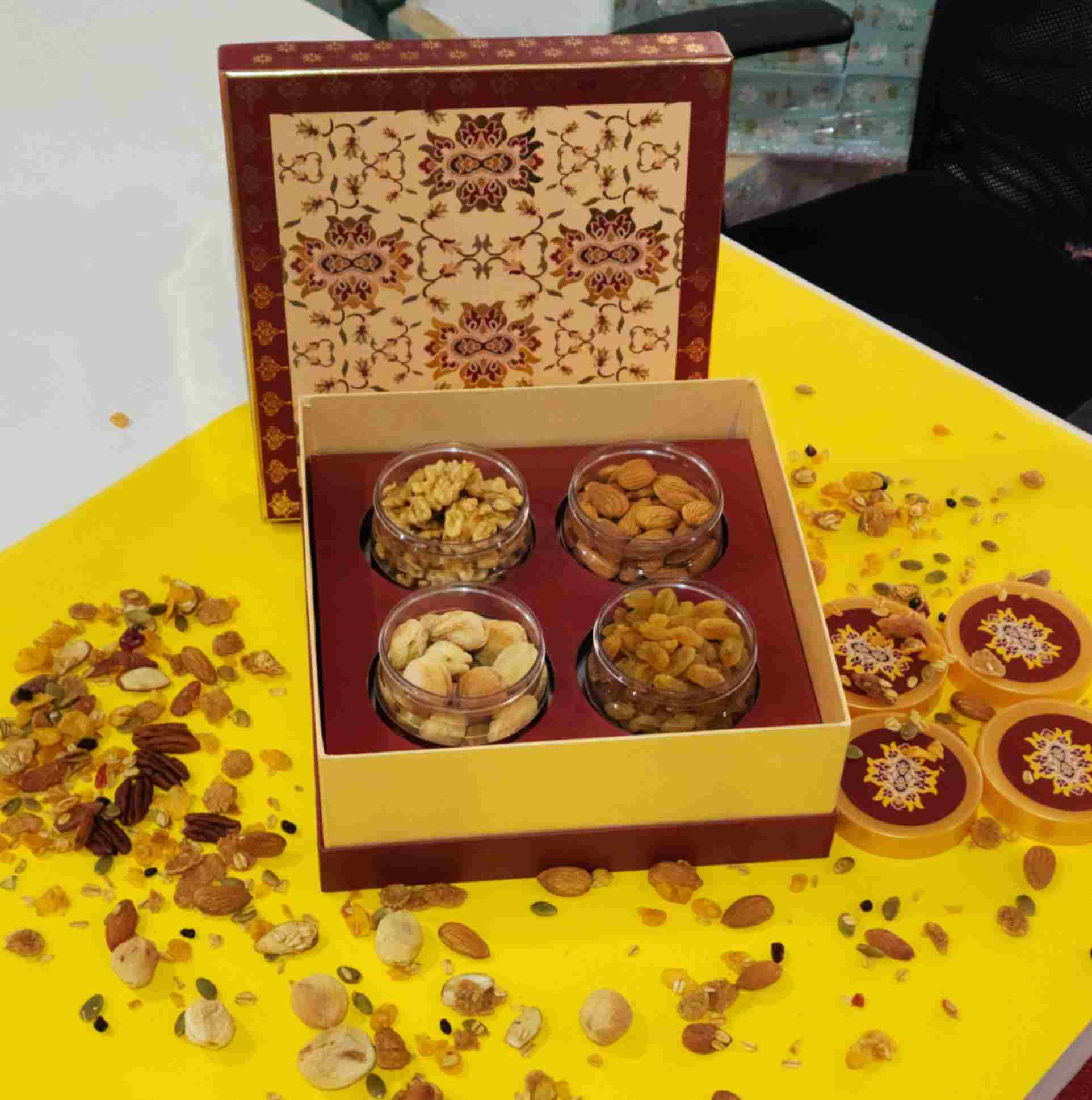 Sufyan Heritage Maroon and Gold 4-Jar Dry Fruit Gift Box featuring clear jars filled with walnuts, almonds, cashews, and raisins with Mughal ornamental lid artwork