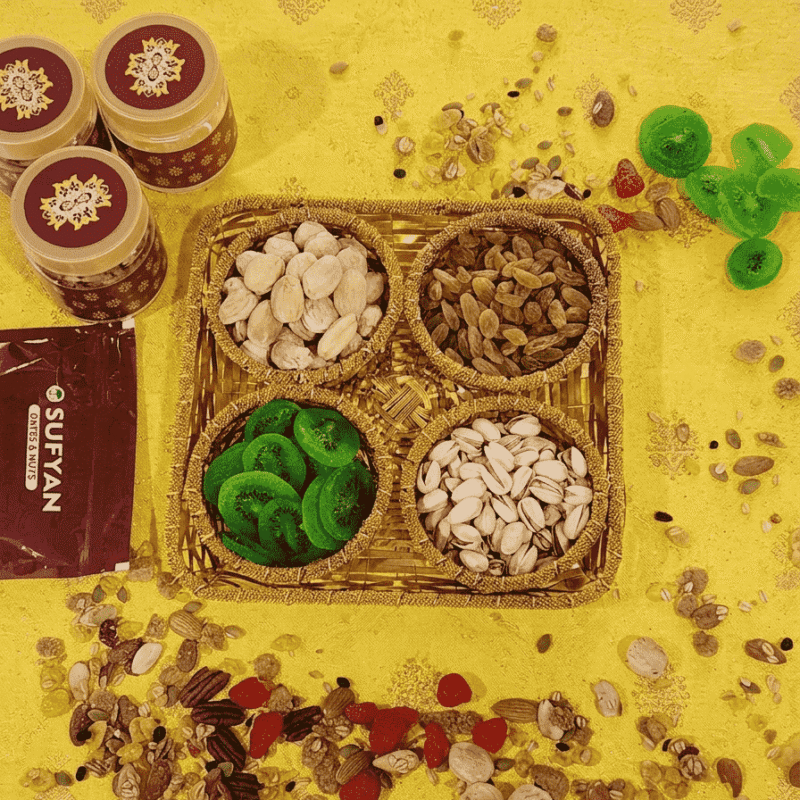 Sufyan Golden Woven Basket Gift Set featuring 4 compartments filled with pistachios, dried kiwi slices, golden raisins, and almonds