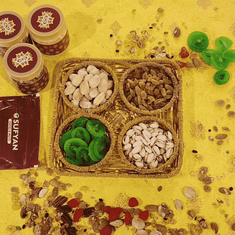 Sufyan Golden Woven Basket Gift Set featuring 4 compartments filled with pistachios, dried kiwi slices, golden raisins, and almonds
